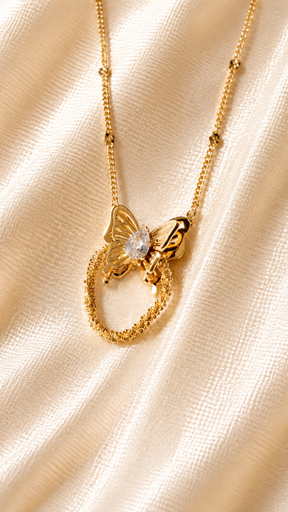 Elegant gold butterfly pendant necklace featuring a sparkling crystal and textured circular design on a fine gold chain, anti-tarnish minimalist jewelry.