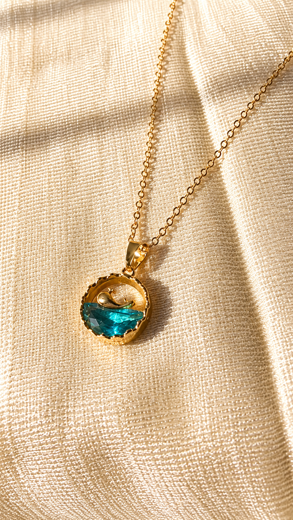 Gold whale ocean pendant necklace with blue crystal wave on a minimalist gold chain, anti-tarnish jewelry by Jewel Minimals.