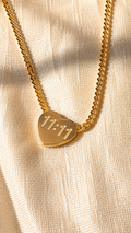 Gold heart pendant necklace engraved with 11:11 on a premium Cuban chain with an anti-tarnish finish by Jewel Minimals.
